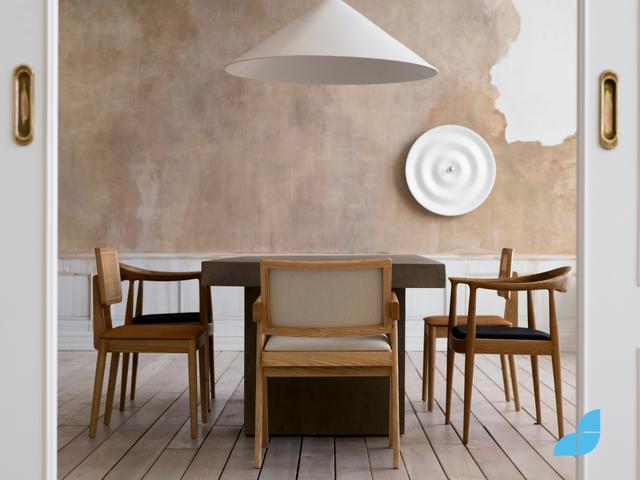 Open white wooden door to dining room with a minimalistic design. Wooden table with wooden chair of different designs